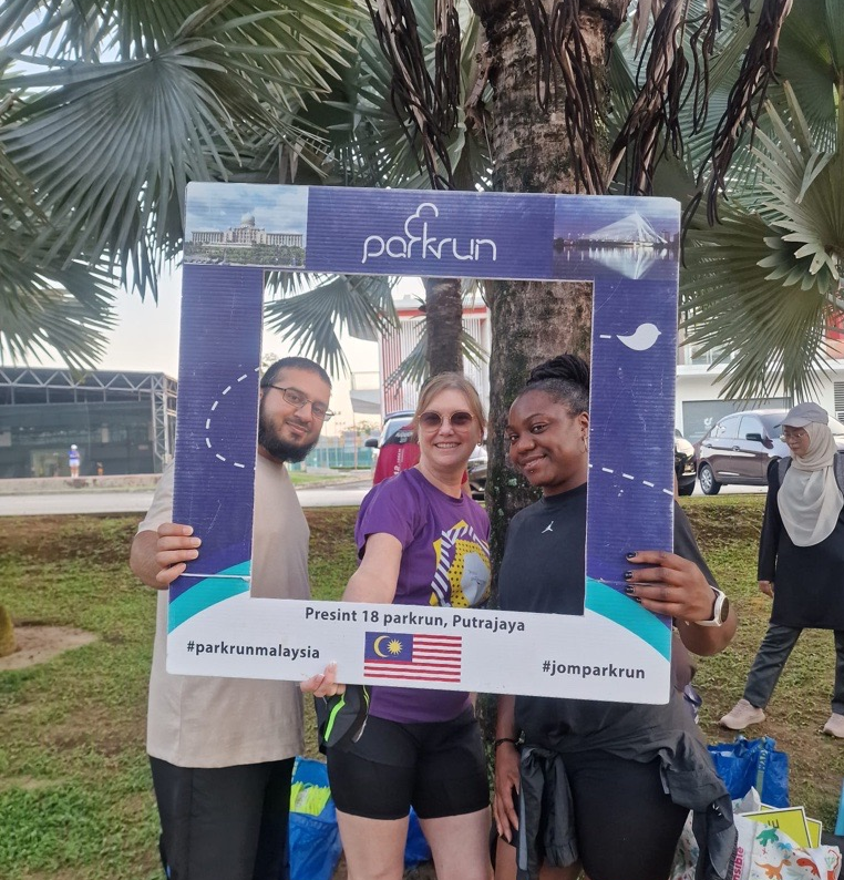 Orange Moon Training learners celebrating after completing a Park Run event in Malaysia